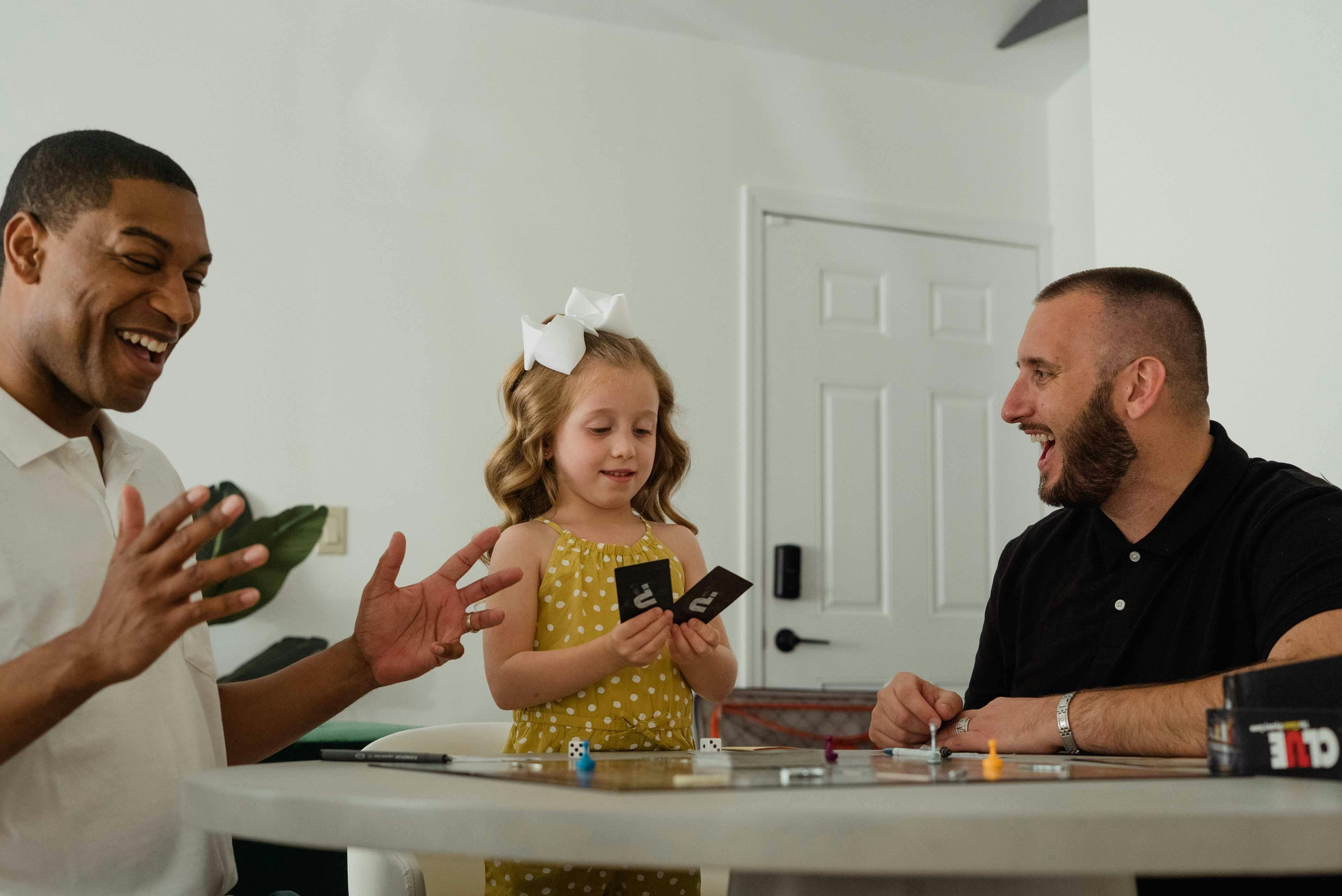 photograph of a family playing a card game