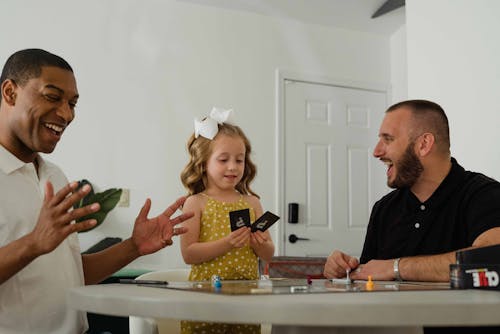 Photograph of a Family Playing a Card Game