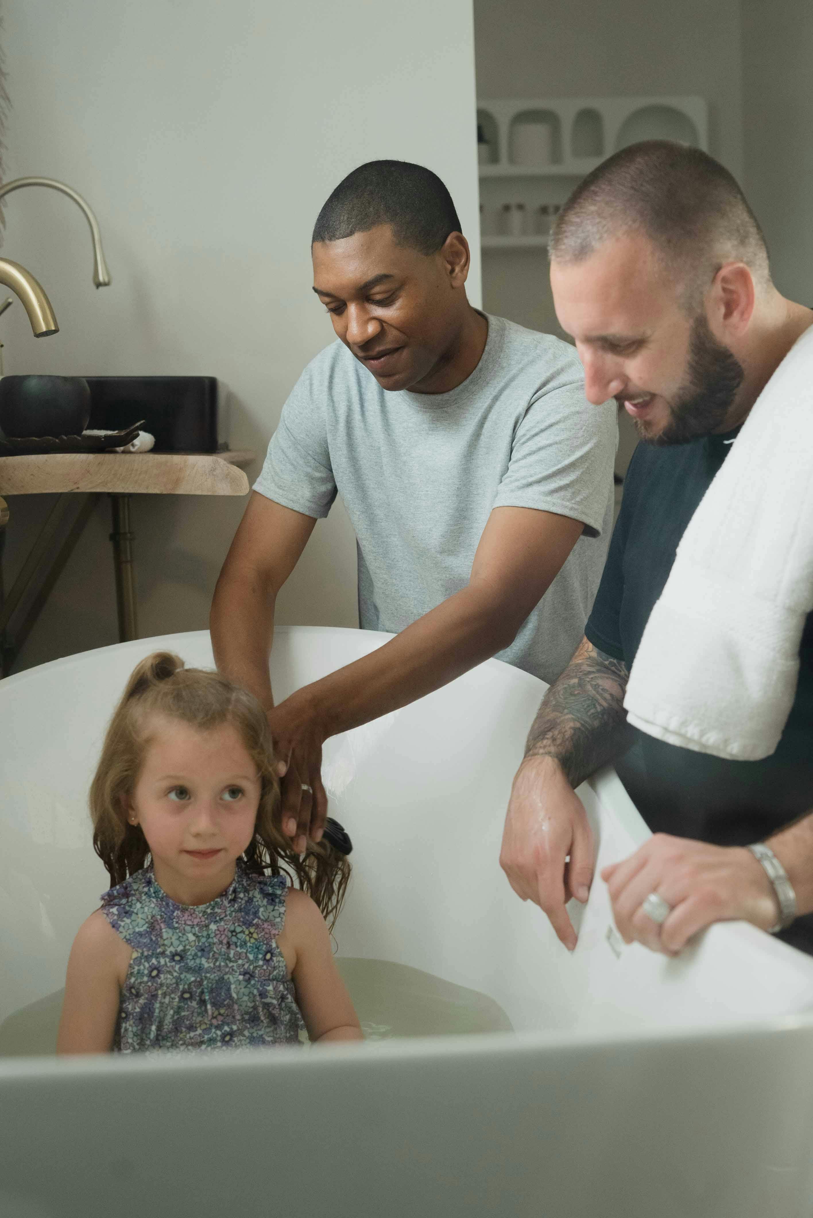 a parent washing a girl s hair