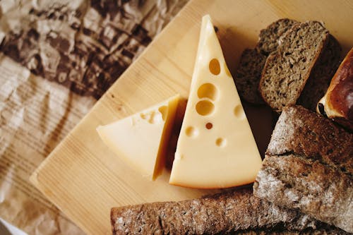 2000: Free Sliced Cheese on Brown Table Top Stock Photo