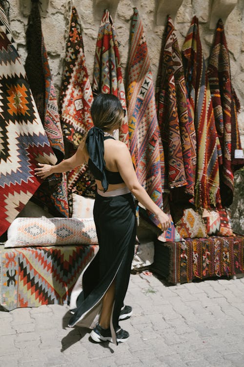Woman Shopping for Blanket at Market