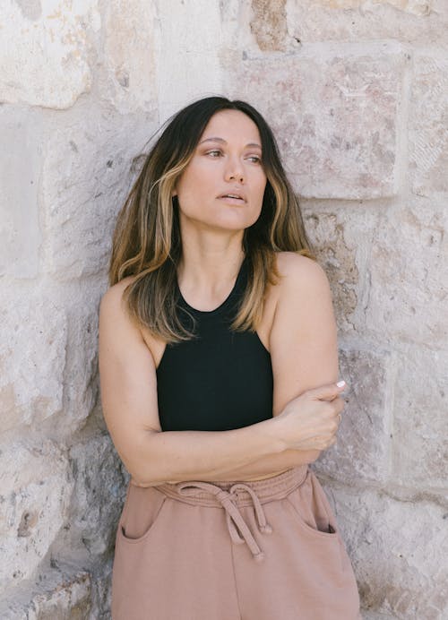 Portrait of a Woman Wearing a Black Top and Brown Pants