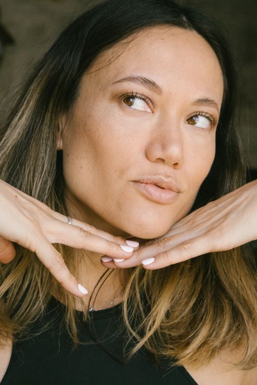 Free Close-up portrait of a young woman posing with manicured nails and thoughtful expression. Stock Photo
