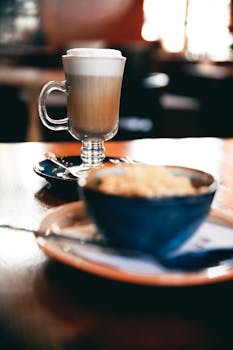 Close-up of a latte in a glass mug on a café table in Pyatigorsk, creating a cozy ambiance.