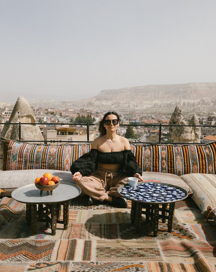 A Woman Sitting At An Al Fresco Lounge