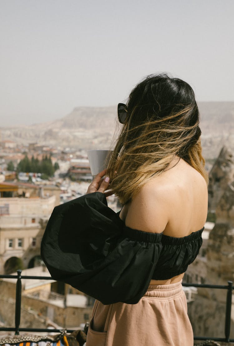 Woman In Black Crop Top Looking At The City Panorama