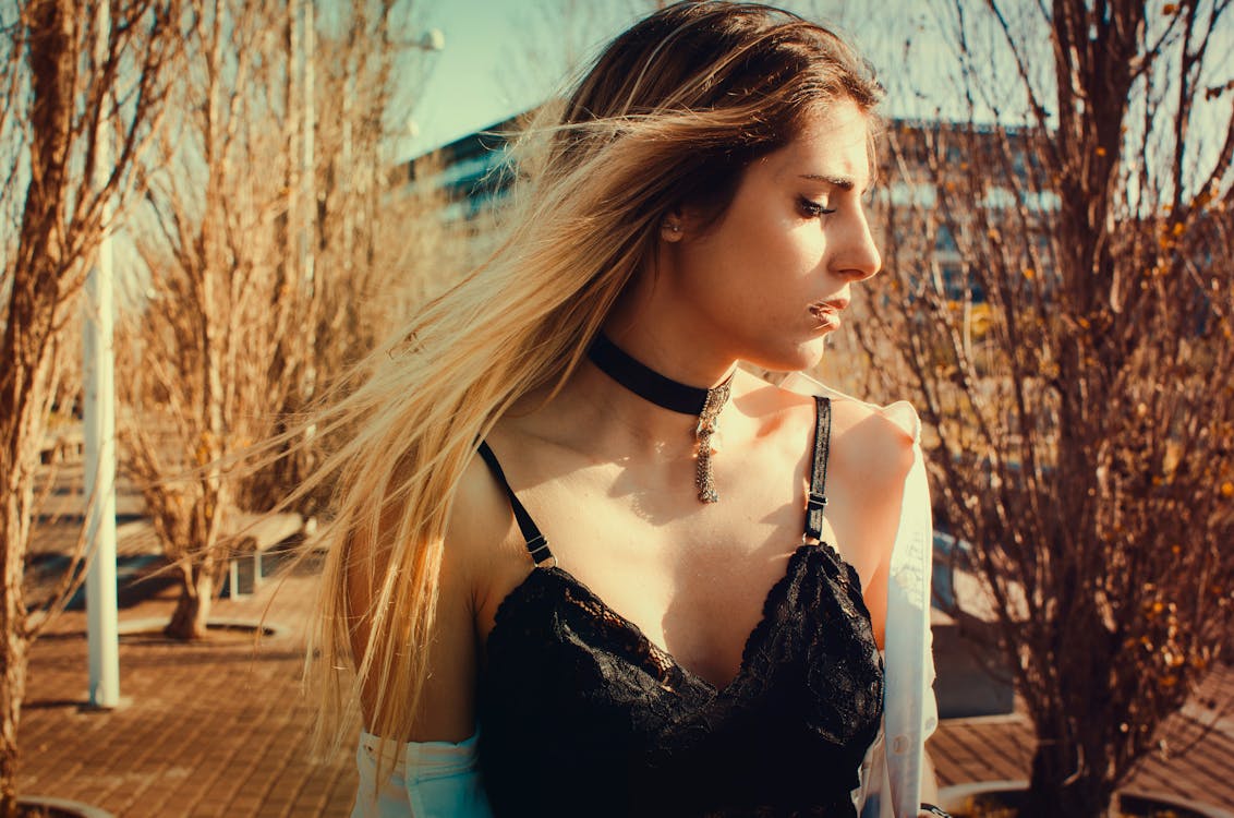 Free Woman Wearing Black Choker and Sleeveless Top Walking on Street Stock Photo