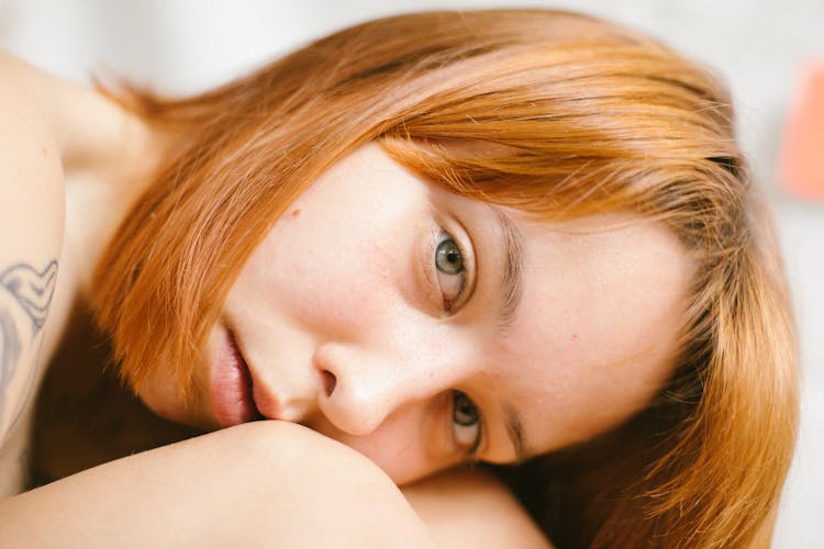 Woman With Red Hair Leaning On Knees