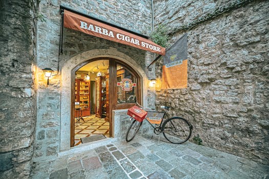 Charming cigar store entrance with a vintage bicycle in Budva, Montenegro.