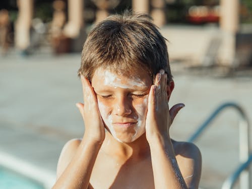 Free A Boy with Sunscreen on His Face Stock Photo