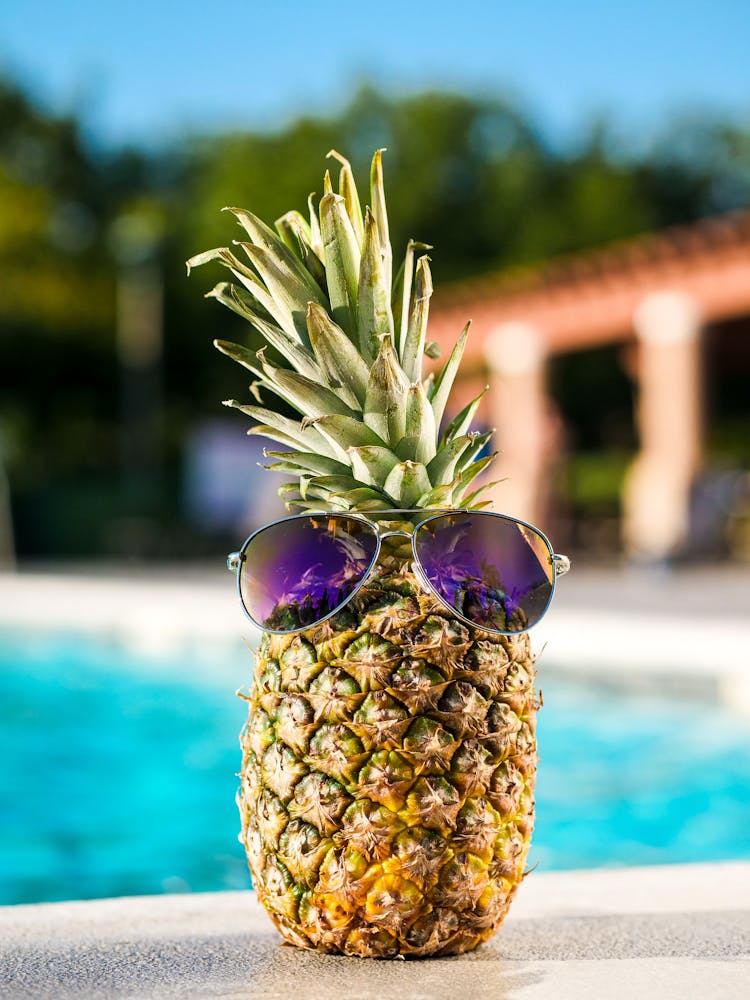 Pineapple With Purple Sunglasses On Poolside