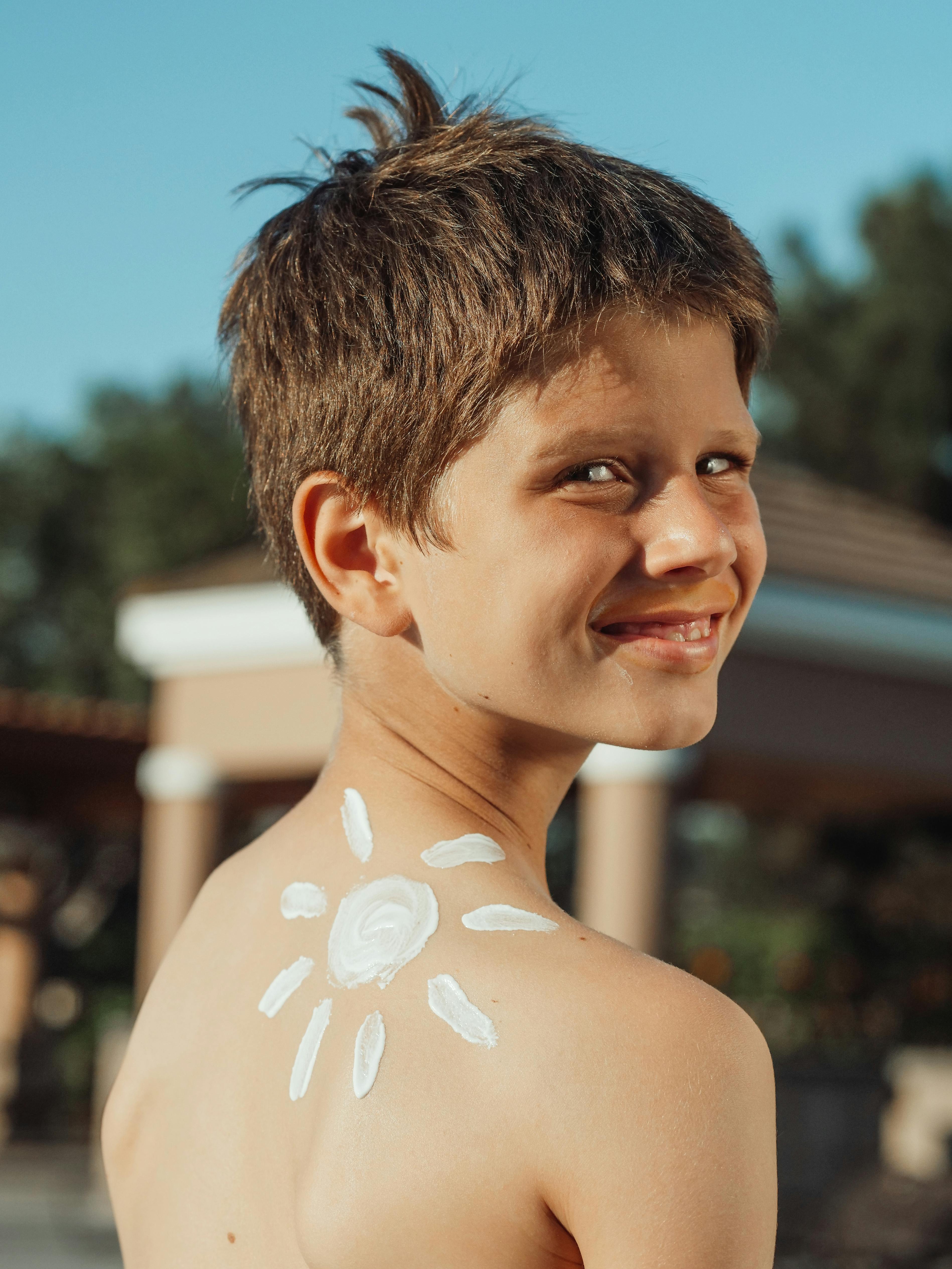 a boy with sunscreen lotion on his skin