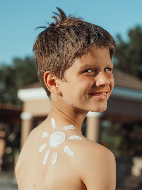 Free A Boy With Sunscreen Lotion on His Skin  Stock Photo