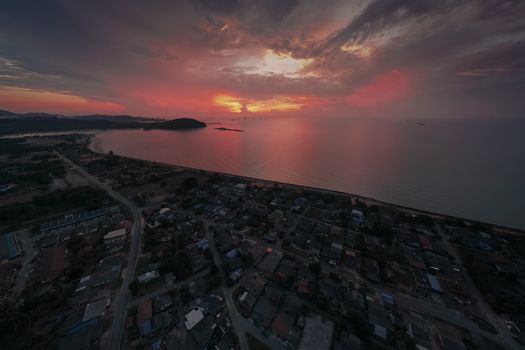 Aerial view of Chukai, Terengganu at sunset with vibrant skies over the coastline.
