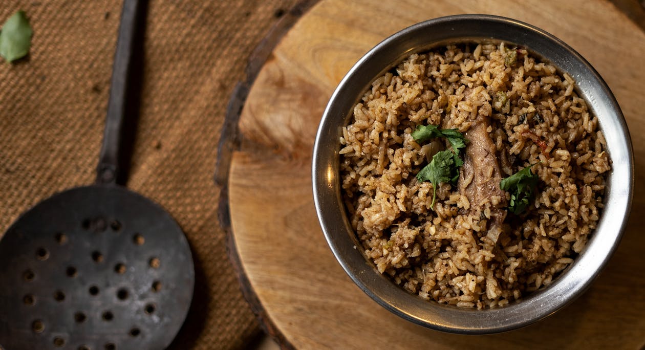 Free A Bowl of Rice and Meat on the Wooden Table Stock Photo