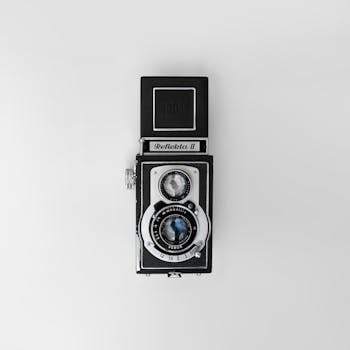 Top-view of a classic Reflecta II twin-lens reflex camera on a white background.