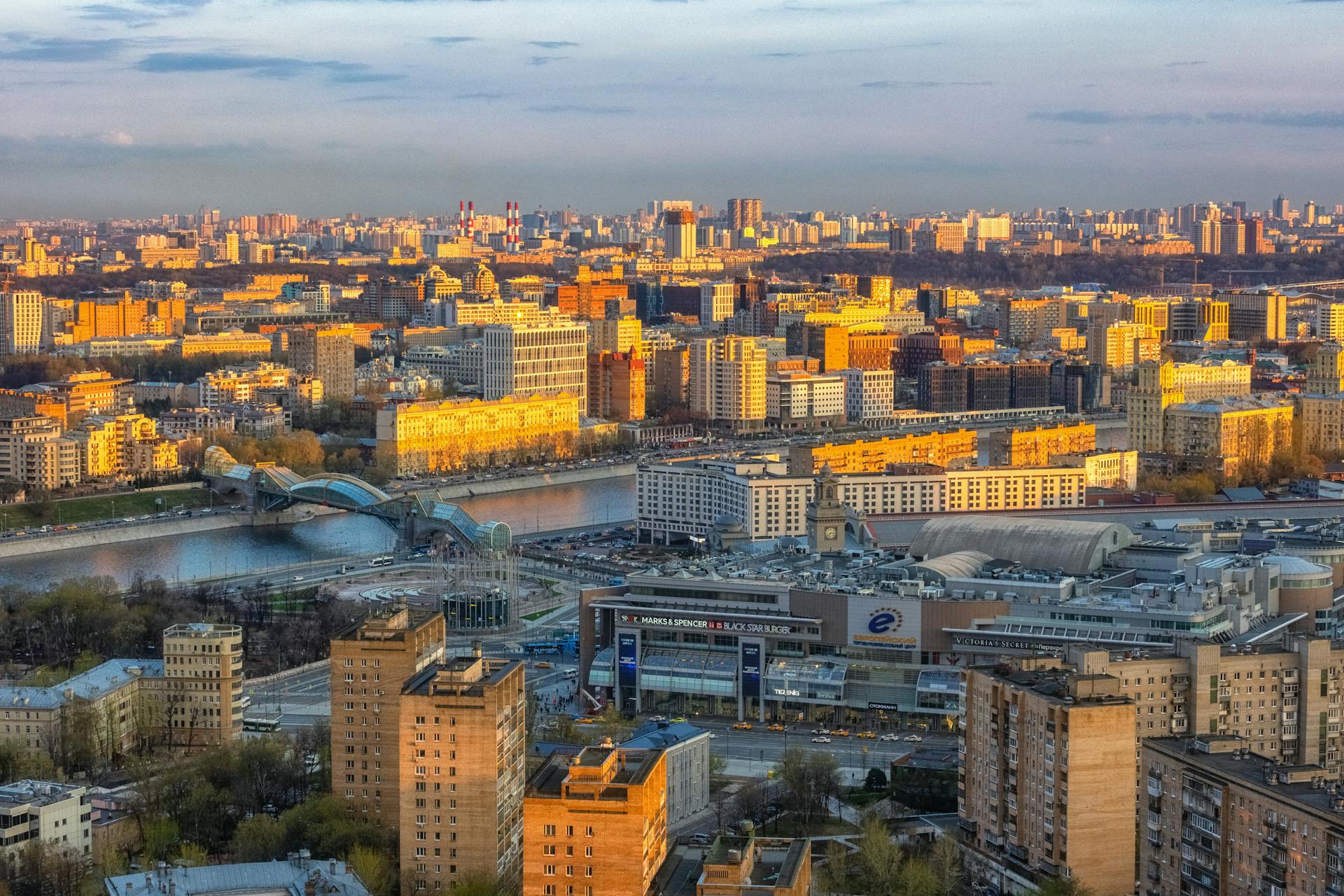 A breathtaking aerial view of Moscow cityscape featuring vibrant architecture illuminated by sunset hues.