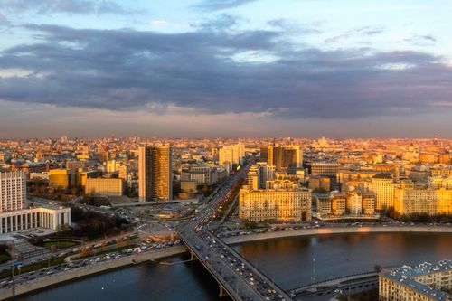 Free A breathtaking aerial view of Moscow cityscape with Novoarbatskiy Bridge and river during sunset. Stock Photo