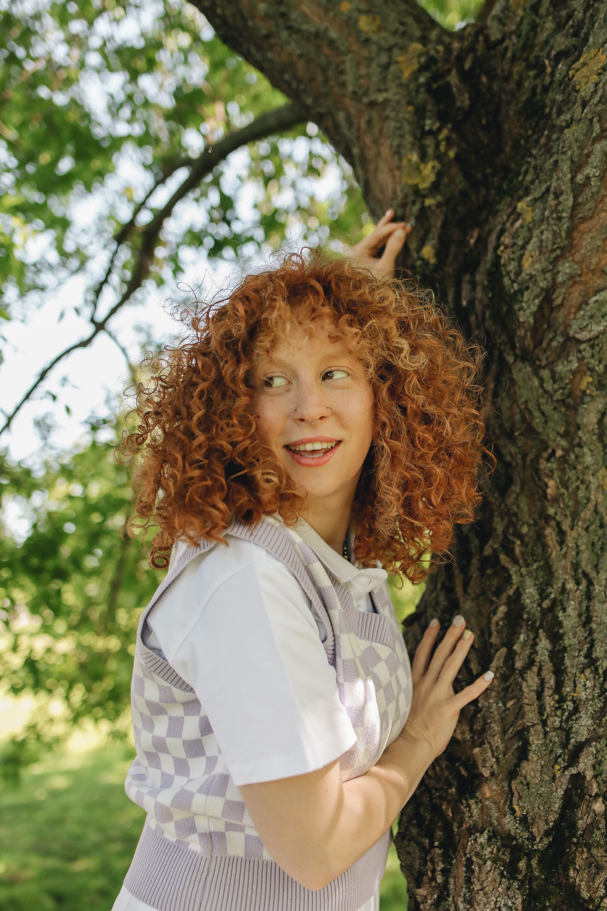 A Woman Standing Beside the Tree Trunk · Free Stock Photo