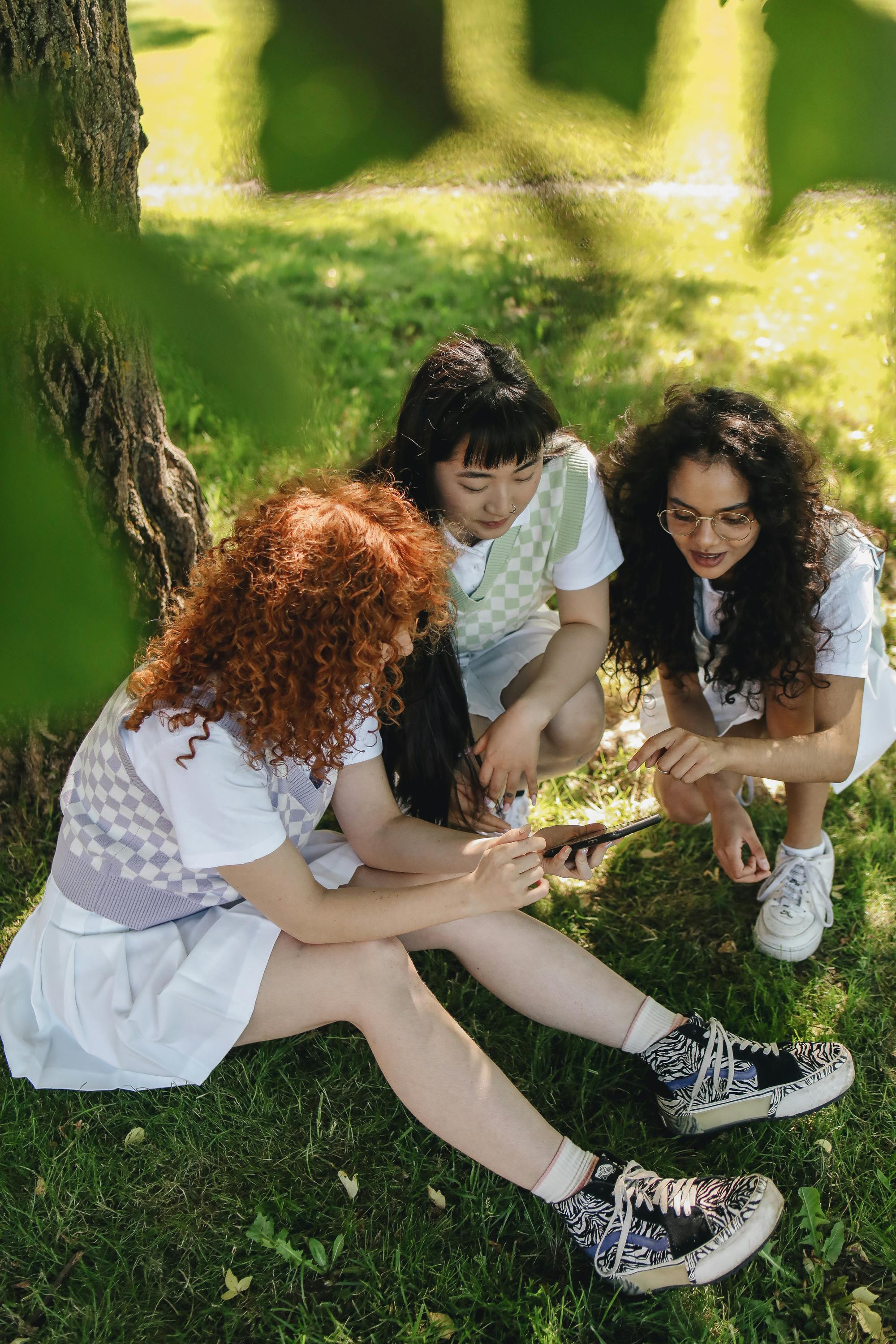 friends sitting on the grass