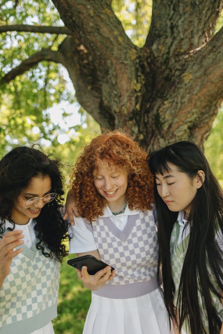 Friends Looking At The Smartphone