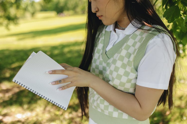 A Young Woman Holding A Notebook