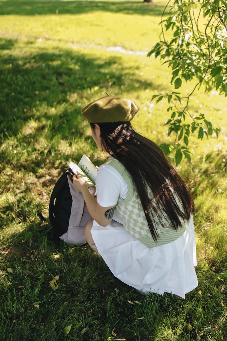 A Student Flipping Pages Of A Book 