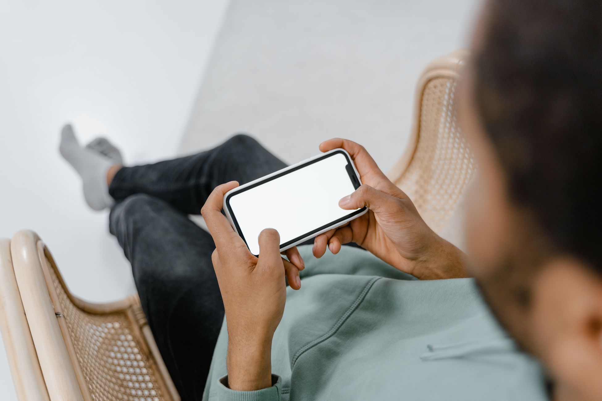 Close-up of hands holding a smartphone indoors, perfect for tech-related content.