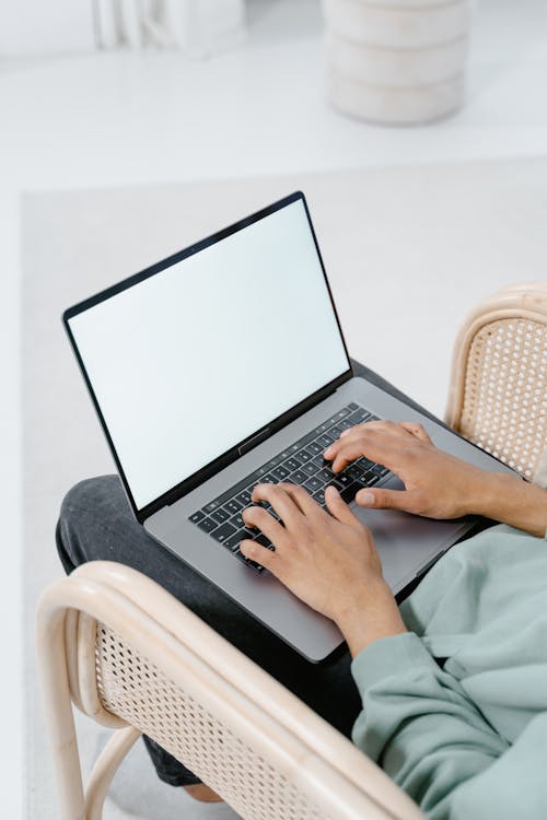 Free A Person Typing on a Laptop  Stock Photo