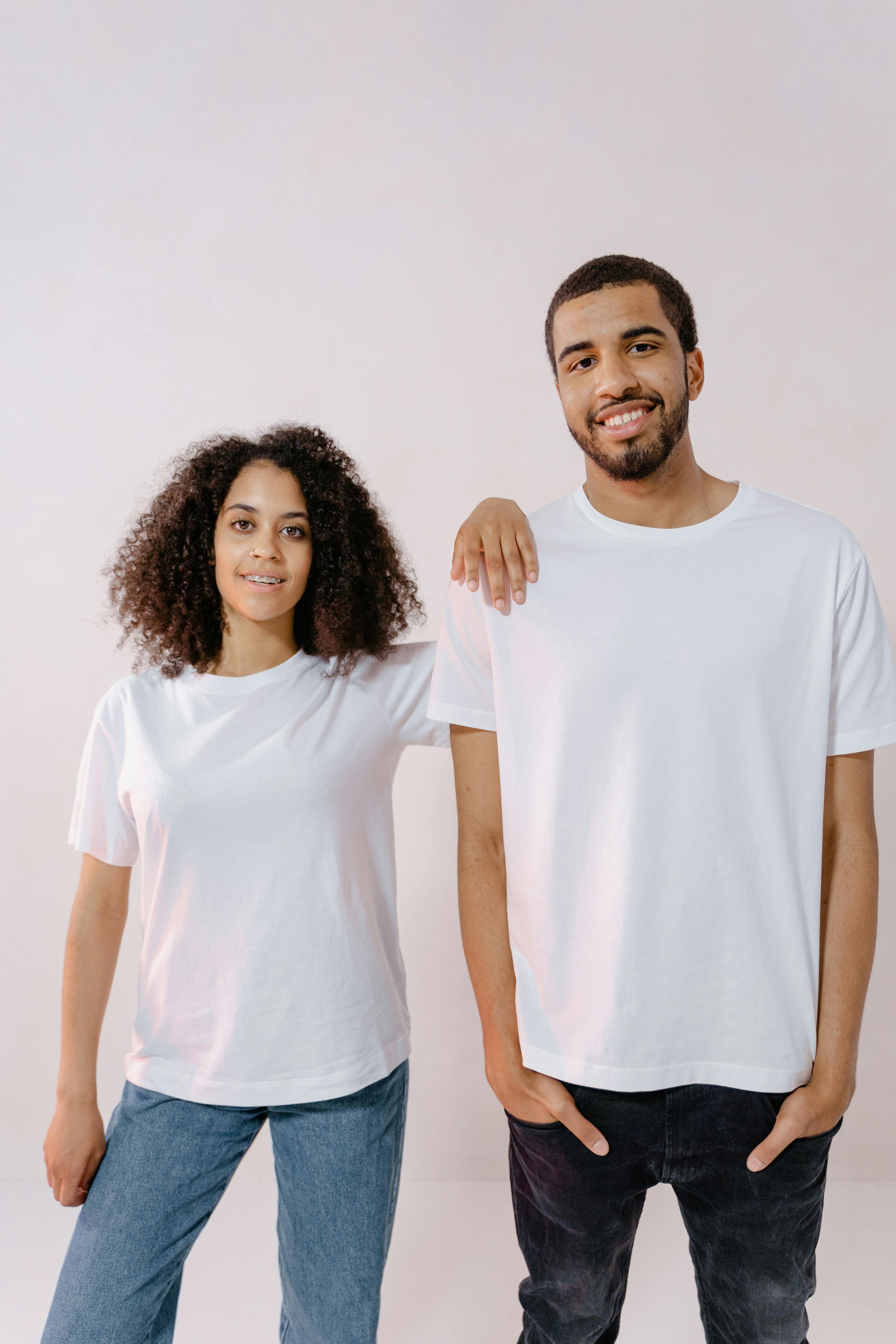 Man in Black T-shirt Holding White and Pink Printer Paper · Free Stock Photo