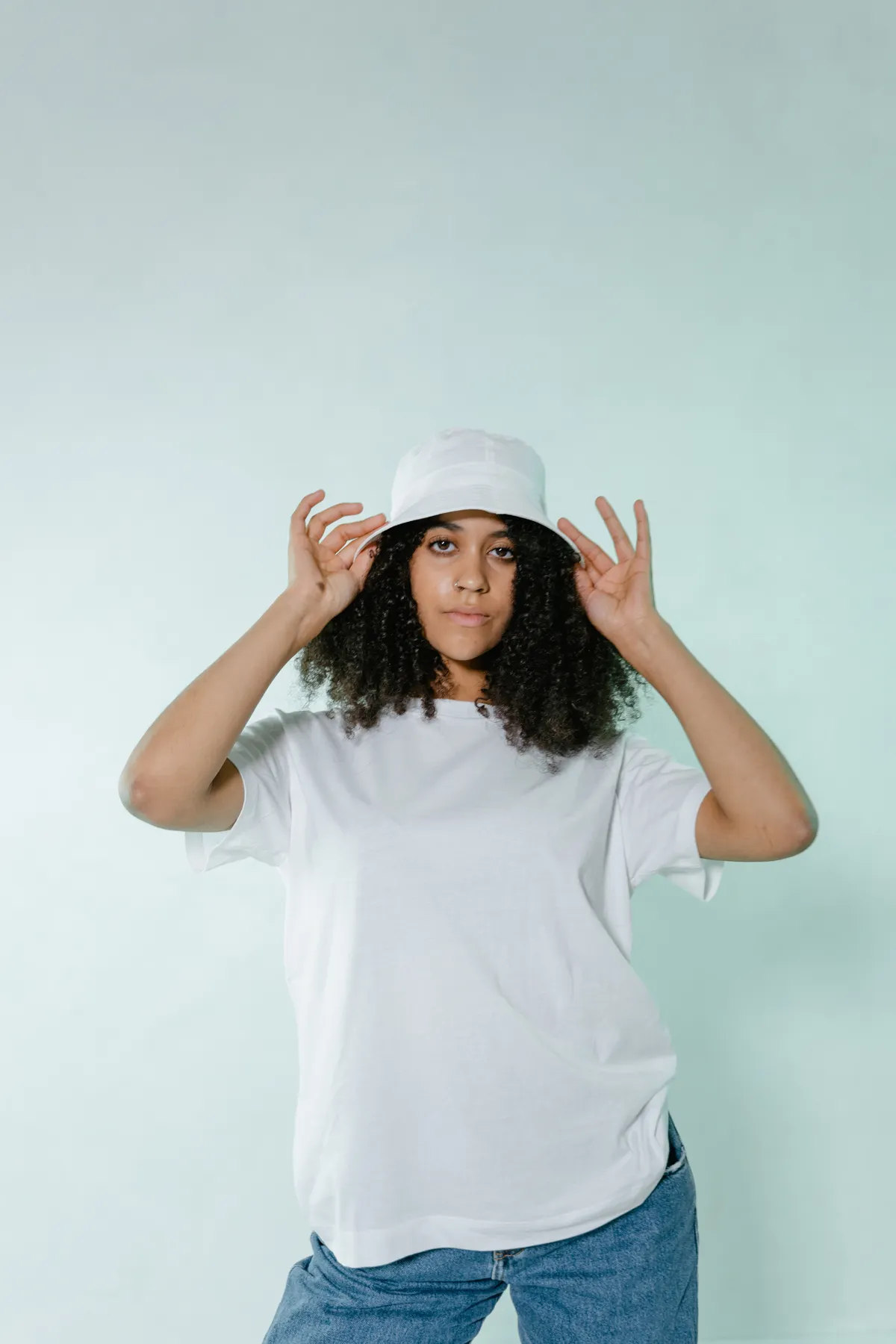 Woman in white tee and bucket hat