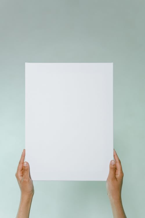 Close-Up Shot of a Person Holding a White Paper