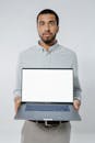 Man Holding a Laptop on White Background