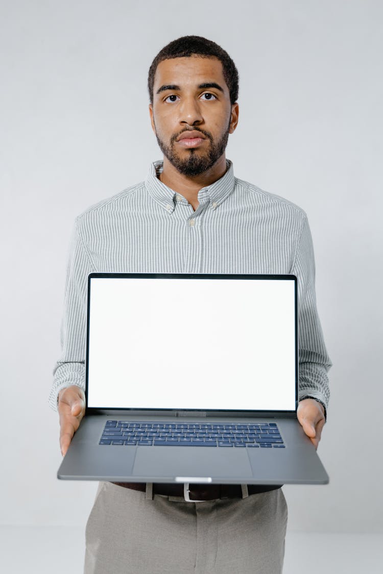 Man Holding A Laptop On White Background