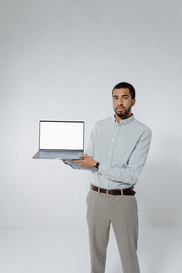 Man Holding A Laptop On White Background