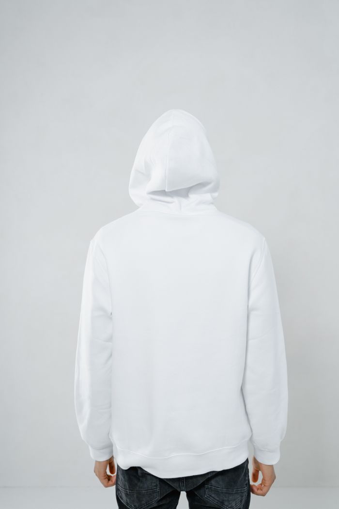 A plain white hoodie shown from the back — photo by MART PRODUCTION on Pexels