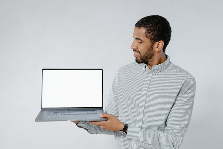 Man Holding A Laptop On White Background
