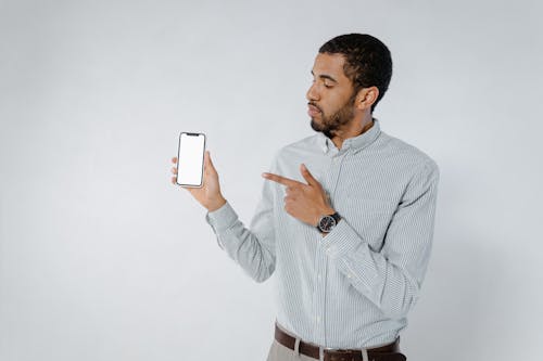 Man Holding a Cellphone on White Background