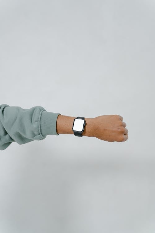 Free Person Wearing a Green Long Sleeves Showing His Smartwatch Stock Photo