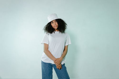 Woman in White T-shirt and Blue Denim Jeans Standing