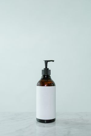 Amber glass pump bottle of hand wash — photo by MART PRODUCTION on Pexels