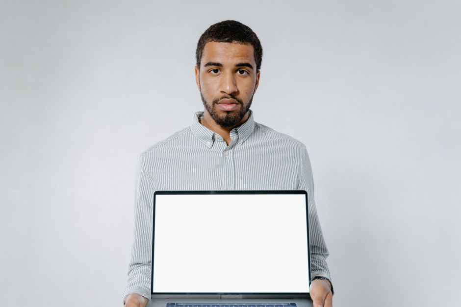 Person speaking into laptop in modern office setting for voice chat lead capture