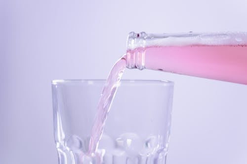 Pouring Beverage on Glass Cup