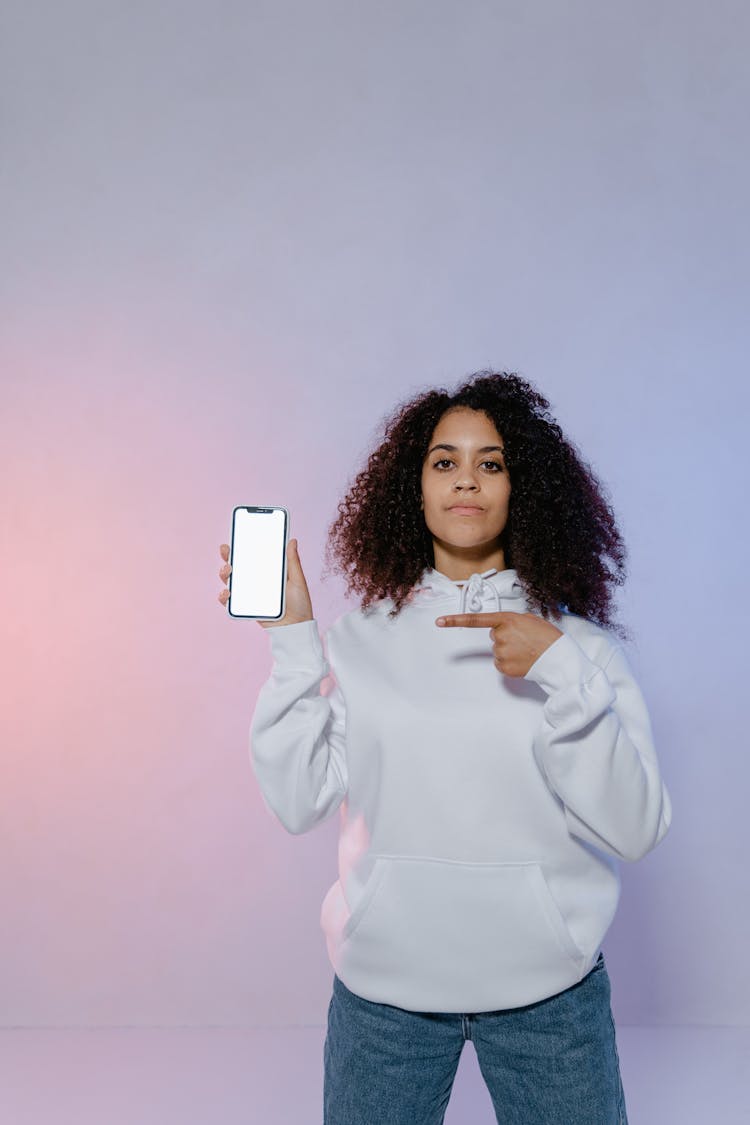 A Woman Pointing To Her Phone