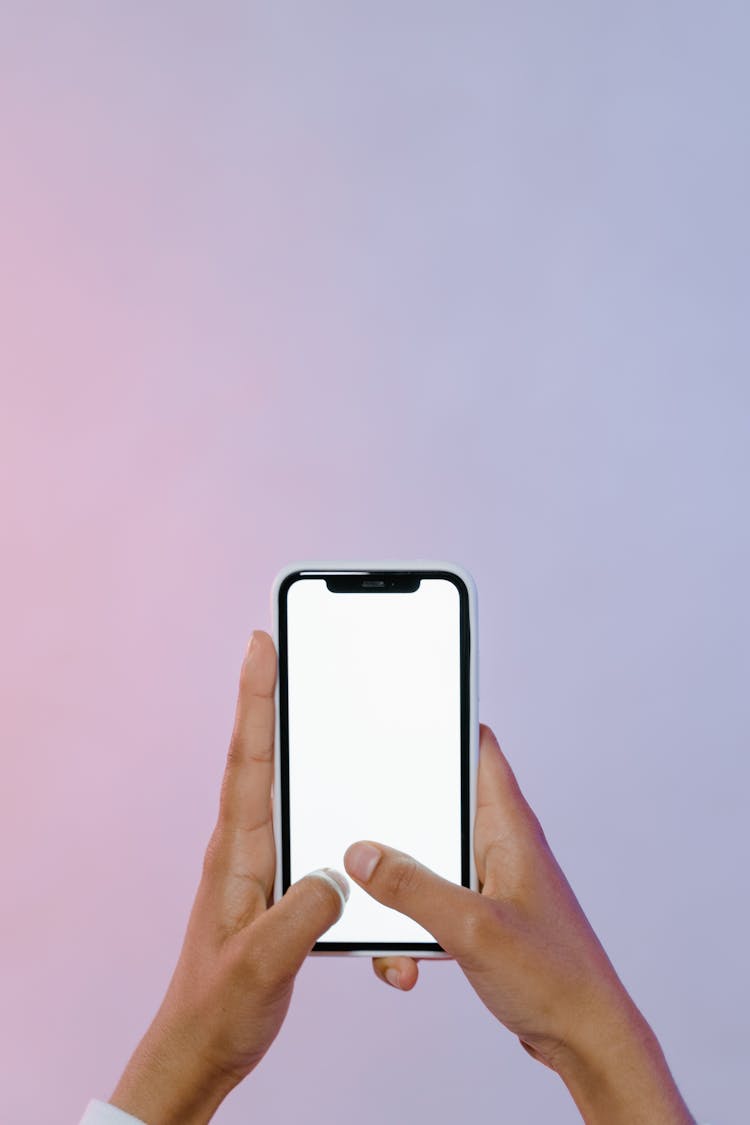 A Person Holding A Smartphone With Blank Screen