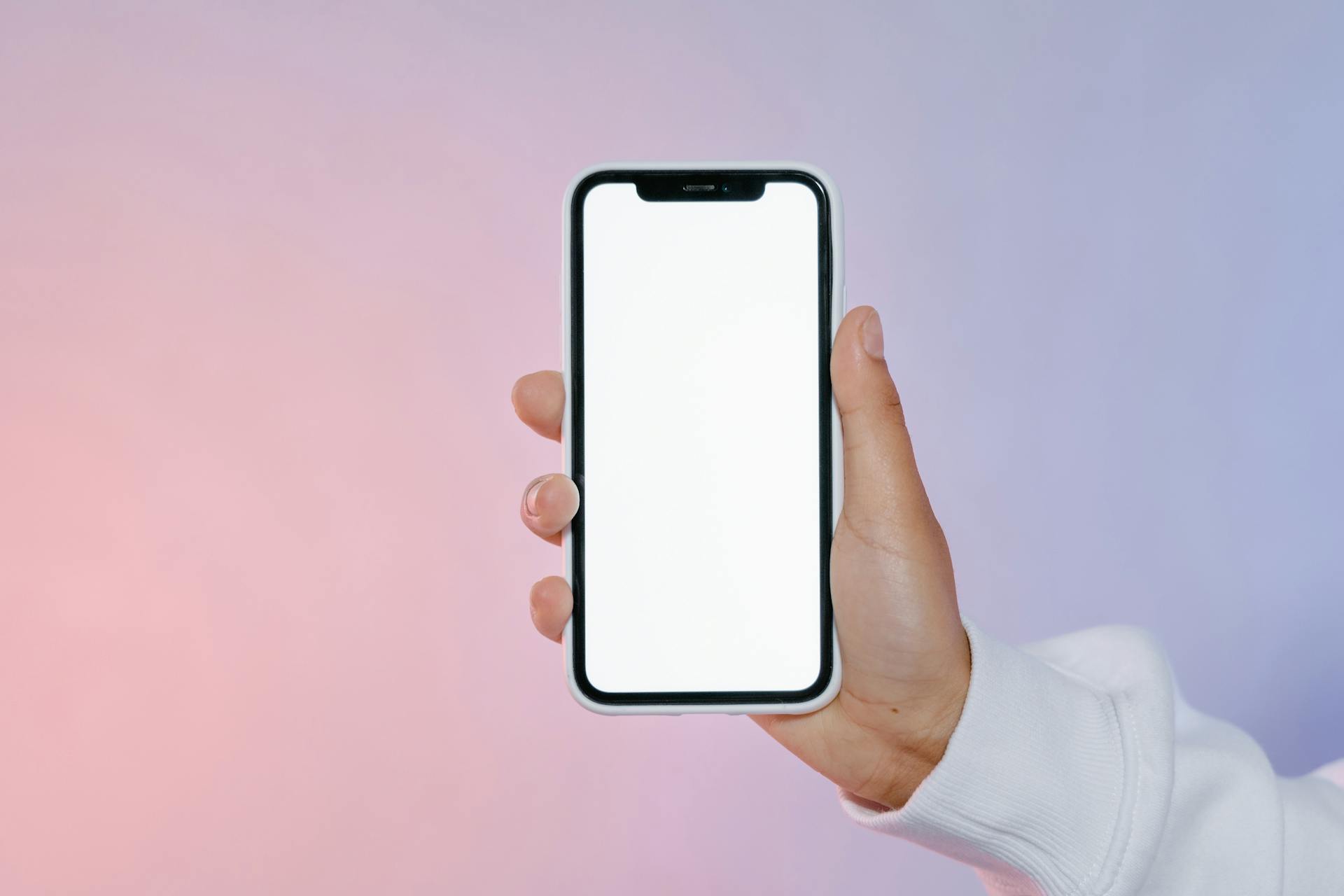 Hand Holding a Smartphone with Blank Screen