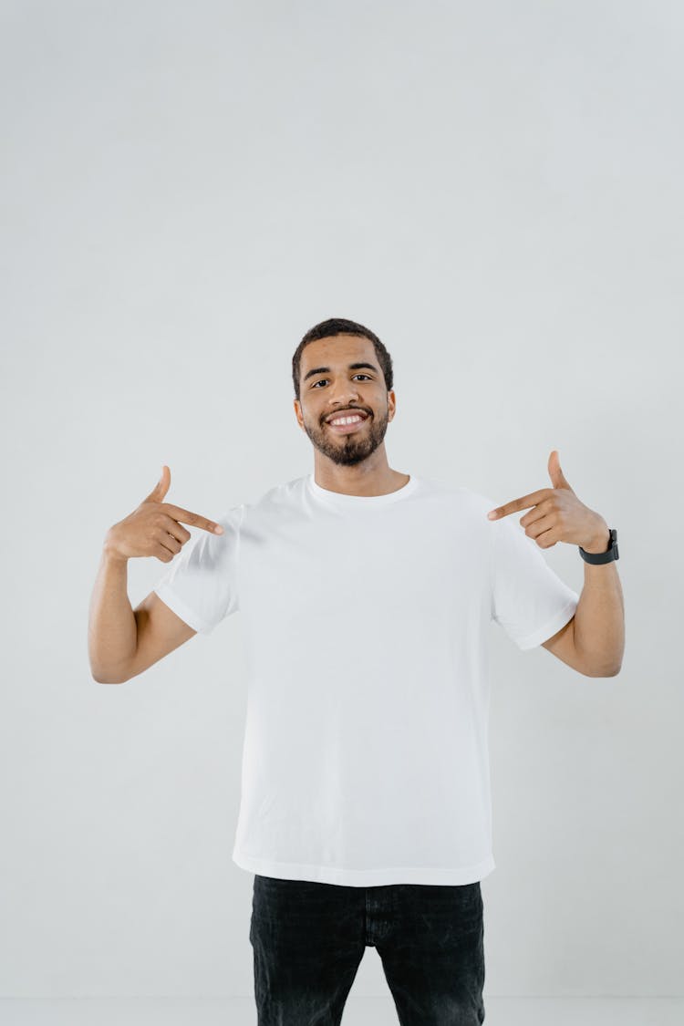 A Man Pointing At His White Shirt