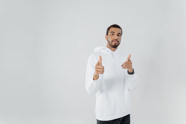 A Man In A White Long Sleeves Sweater Posing