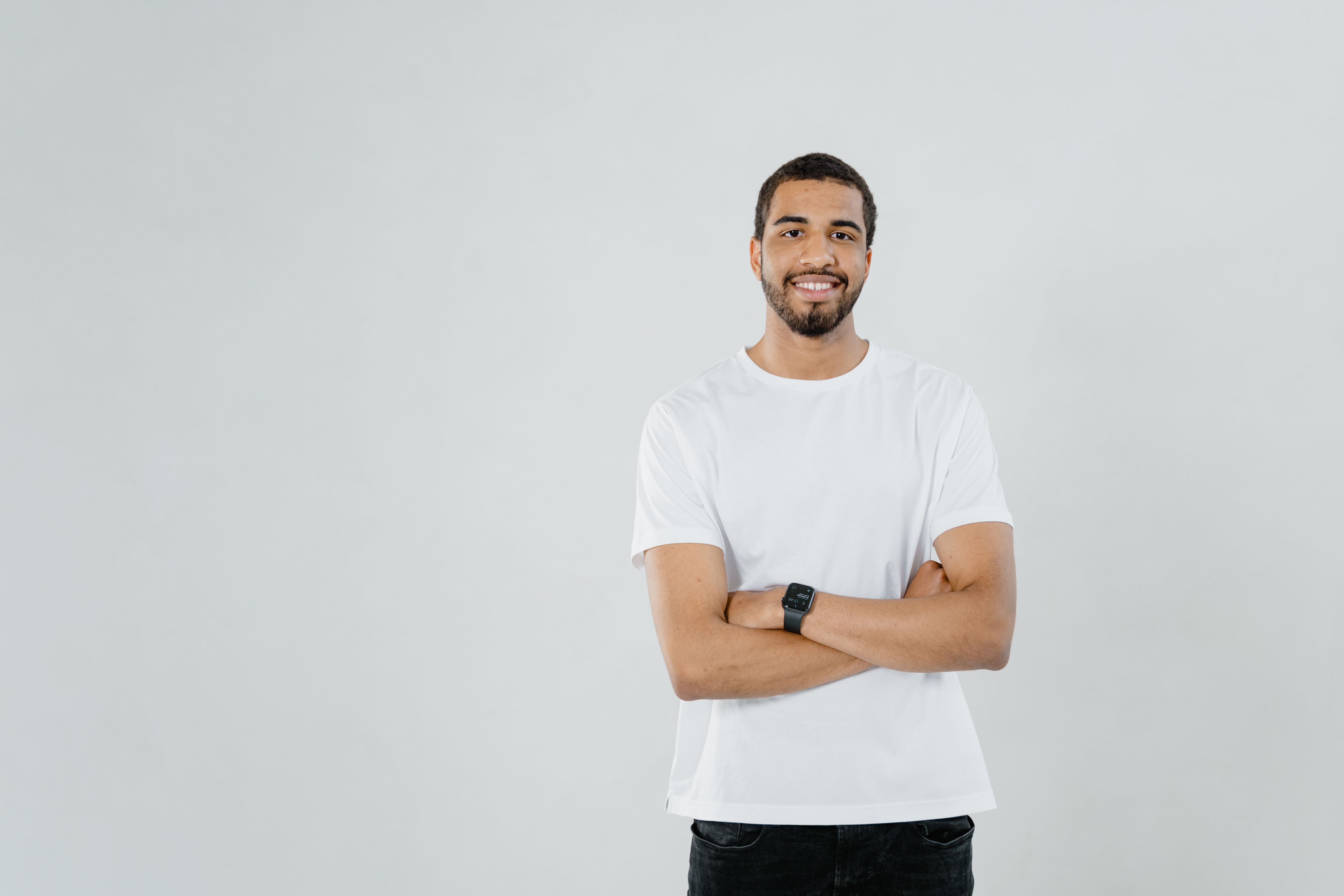 A man with an open, relaxed posture and an easy half-smile — warm-neutral, not braced.