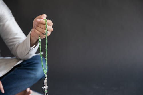 Person Holding Prayer Beads